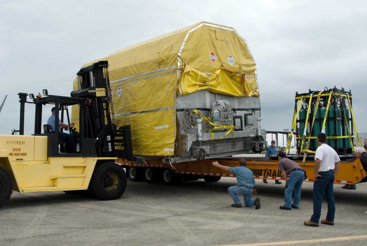 CAPE CANAVERAL, Fla. – At the Shuttle Landing Facility at NASA's Kennedy Space Center in Florida, workers lift NASA's GOES-P meteorological satellite onto a transporter for its move to the Astrotech Space Operations facility in Titusville, Fla., for final processing for launch. GOES-P, the latest Geostationary Operational Environmental Satellite, was developed by NASA for the National Oceanic and Atmospheric Administration, or NOAA. GOES-P is designed to watch for storm development and observed current weather conditions on Earth. Launch of GOES-P is targeted for no earlier than Feb. 25, 2010, from Launch Complex 37 aboard a United Launch Alliance Delta IV rocket. For information on GOES-P, visit http://goespoes.gsfc.nasa.gov/goes/spacecraft/n_p_spacecraft.html. Photo credit: NASA/Amanda Diller