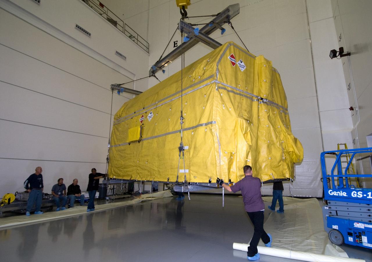 CAPE CANAVERAL, Fla. – At the Astrotech Space Operations facility in Titusville, Fla., workers lift NASA's GOES-P meteorological satellite from the transporter which delivered it from NASA Kennedy Space Center's Shuttle Landing Facility. GOES-P, the latest Geostationary Operational Environmental Satellite, was developed by NASA for the National Oceanic and Atmospheric Administration, or NOAA. GOES-P is designed to watch for storm development and observed current weather conditions on Earth. Launch of GOES-P is targeted for no earlier than Feb. 25, 2010, from Launch Complex 37 aboard a United Launch Alliance Delta IV rocket. For information on GOES-P, visit http://goespoes.gsfc.nasa.gov/goes/spacecraft/n_p_spacecraft.html. Photo credit: NASA/Amanda Diller