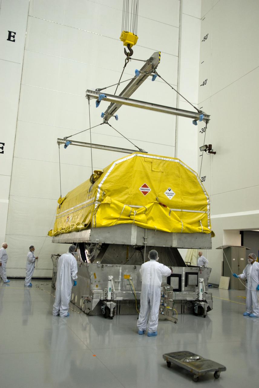CAPE CANAVERAL, Fla. – At the Astrotech Space Operations facility in Titusville, Fla., workers lift the transportation cover from NASA's newly arrived GOES-P meteorological satellite.    GOES-P, the latest Geostationary Operational Environmental Satellite, was developed by NASA for the National Oceanic and Atmospheric Administration, or NOAA.  GOES-P is designed to watch for storm development and observed current weather conditions on Earth.  Launch of GOES-P is targeted for no earlier than Feb. 25, 2010, from Launch Complex 37 aboard a United Launch Alliance Delta IV rocket.  For information on GOES-P, visit http://goespoes.gsfc.nasa.gov/goes/spacecraft/n_p_spacecraft.html. Photo credit: NASA/Glenn Benson