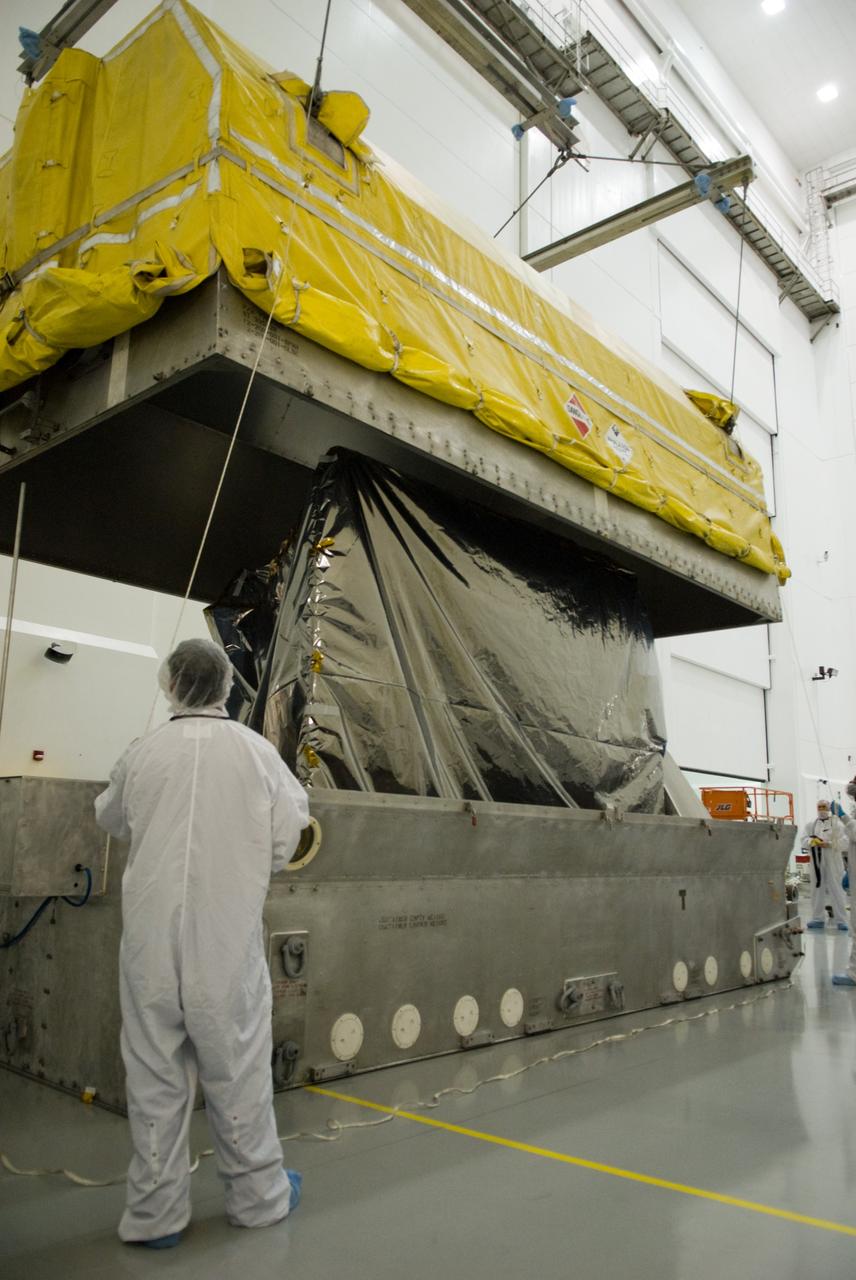 CAPE CANAVERAL, Fla. – At the Astrotech Space Operations facility in Titusville, Fla., workers uncrate NASA's newly arrived GOES-P meteorological satellite.    GOES-P, the latest Geostationary Operational Environmental Satellite, was developed by NASA for the National Oceanic and Atmospheric Administration, or NOAA.  GOES-P is designed to watch for storm development and observed current weather conditions on Earth.  Launch of GOES-P is targeted for no earlier than Feb. 25, 2010, from Launch Complex 37 aboard a United Launch Alliance Delta IV rocket.  For information on GOES-P, visit http://goespoes.gsfc.nasa.gov/goes/spacecraft/n_p_spacecraft.html. Photo credit: NASA/Glenn Benson
