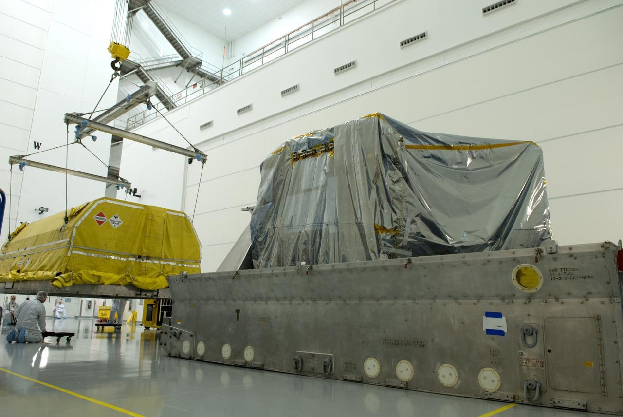 CAPE CANAVERAL, Fla. – At the Astrotech Space Operations facility in Titusville, Fla., workers remove the transportation cover from NASA's newly arrived GOES-P meteorological satellite.    GOES-P, the latest Geostationary Operational Environmental Satellite, was developed by NASA for the National Oceanic and Atmospheric Administration, or NOAA.  GOES-P is designed to watch for storm development and observed current weather conditions on Earth.  Launch of GOES-P is targeted for no earlier than Feb. 25, 2010, from Launch Complex 37 aboard a United Launch Alliance Delta IV rocket.  For information on GOES-P, visit http://goespoes.gsfc.nasa.gov/goes/spacecraft/n_p_spacecraft.html. Photo credit: NASA/Glenn Benson