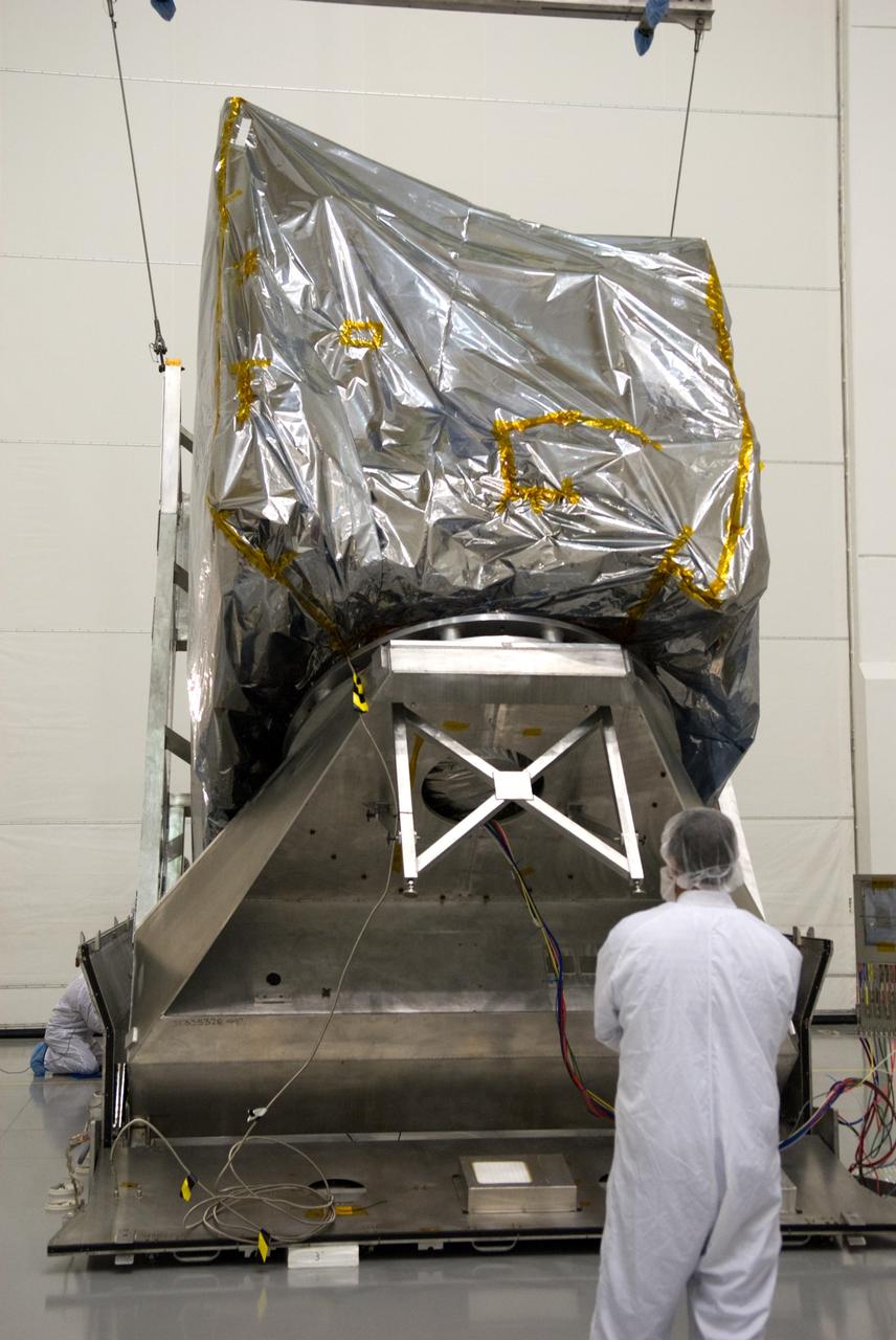 CAPE CANAVERAL, Fla. – At the Astrotech Space Operations facility in Titusville, Fla., NASA's newly arrived GOES-P meteorological satellite is lifted into a vertical position for removal from its transportation case.    GOES-P, the latest Geostationary Operational Environmental Satellite, was developed by NASA for the National Oceanic and Atmospheric Administration, or NOAA.  GOES-P is designed to watch for storm development and observed current weather conditions on Earth.  Launch of GOES-P is targeted for no earlier than Feb. 25, 2010, from Launch Complex 37 aboard a United Launch Alliance Delta IV rocket.  For information on GOES-P, visit http://goespoes.gsfc.nasa.gov/goes/spacecraft/n_p_spacecraft.html. Photo credit: NASA/Glenn Benson
