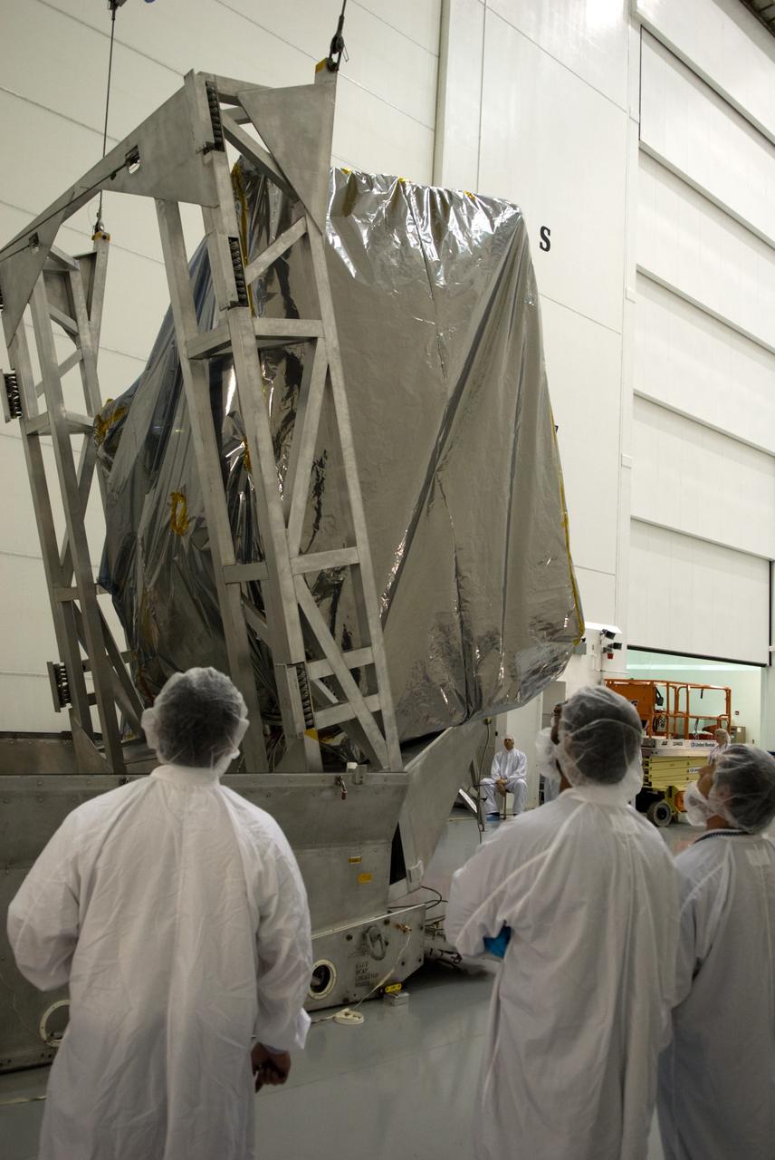 CAPE CANAVERAL, Fla. – At the Astrotech Space Operations facility in Titusville, Fla., workers monitor NASA's newly arrived GOES-P meteorological satellite as it is lifted into a vertical position for removal from its transportation case. GOES-P, the latest Geostationary Operational Environmental Satellite, was developed by NASA for the National Oceanic and Atmospheric Administration, or NOAA. GOES-P is designed to watch for storm development and observed current weather conditions on Earth. Launch of GOES-P is targeted for no earlier than Feb. 25, 2010, from Launch Complex 37 aboard a United Launch Alliance Delta IV rocket. For information on GOES-P, visit http://goespoes.gsfc.nasa.gov/goes/spacecraft/n_p_spacecraft.html. Photo credit: NASA/Glenn Benson