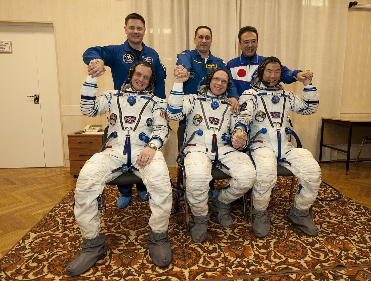 KAZAKHASTAN - 200912210001HQ - Expedition 22 crew members, seated from left, NASA Flight Engineer Timothy J. Creamer of the United States, Soyuz Commander Oleg Kotov of Russia, and Flight Engineer Soichi Noguchi of Japan pose for a group photo with their backup crew members, standing from left, NASA’s Doug Wheelock, Russian Anton Shkaplerov, and Japan’s Satoshi Furakawa, just a few hours before the scheduled launch of the Soyuz TMA-17 spacecraft from the Baikonur Cosmodrome in Kazakhstan, Monday, Dec. 21, 2009.  Photo Credit: NASA/Bill Ingalls