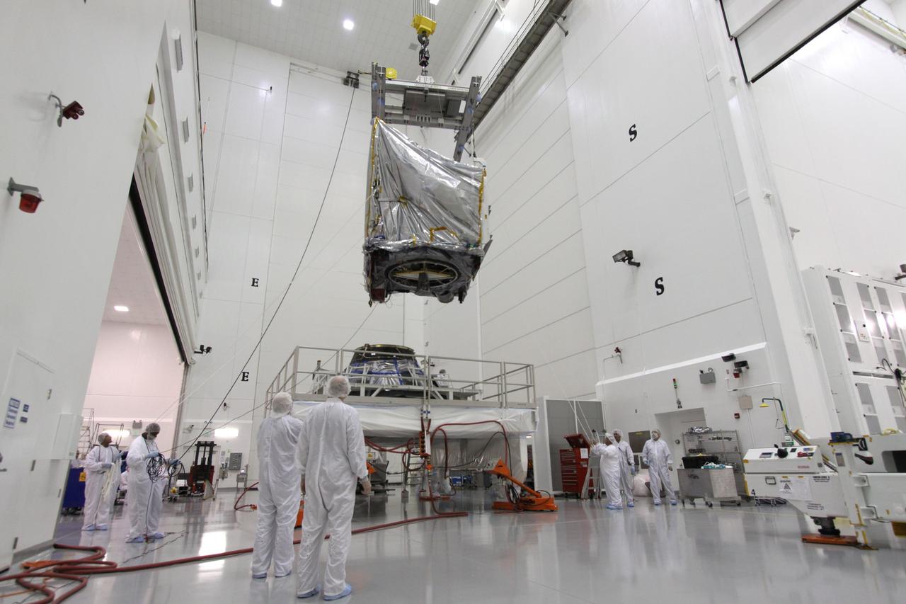 CAPE CANAVERAL, Fla. – At the Astrotech Space Operations facility in Titusville, Fla., NASA's GOES-P meteorological satellite, covered in a protective bag, is lowered toward a Ransome table on which it will be secured and rotated for further testing. GOES-P, the latest Geostationary Operational Environmental Satellite, was developed by NASA for the National Oceanic and Atmospheric Administration, or NOAA. GOES-P is designed to watch for storm development and observed current weather conditions on Earth. Launch of GOES-P is targeted for no earlier than Feb. 25, 2010, from Launch Complex 37 aboard a United Launch Alliance Delta IV rocket. For information on GOES-P, visit http://goespoes.gsfc.nasa.gov/goes/spacecraft/n_p_spacecraft.html. Photo credit: NASA/Jack Pfaller