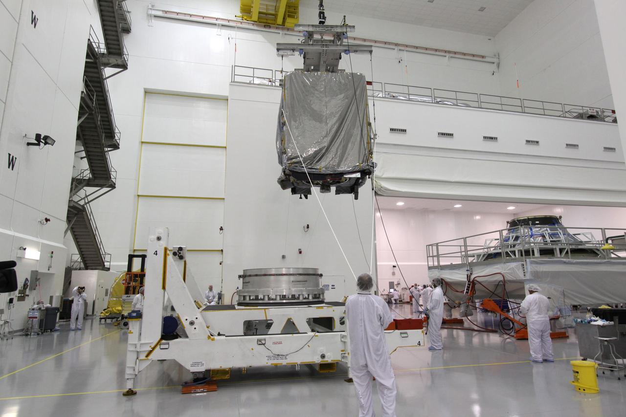 CAPE CANAVERAL, Fla. – At the Astrotech Space Operations facility in Titusville, Fla., workers guide NASA's GOES-P meteorological satellite, covered in a protective bag, toward a Ransome table on which it will be secured and rotated for further testing. GOES-P, the latest Geostationary Operational Environmental Satellite, was developed by NASA for the National Oceanic and Atmospheric Administration, or NOAA. GOES-P is designed to watch for storm development and observed current weather conditions on Earth. Launch of GOES-P is targeted for no earlier than Feb. 25, 2010, from Launch Complex 37 aboard a United Launch Alliance Delta IV rocket. For information on GOES-P, visit http://goespoes.gsfc.nasa.gov/goes/spacecraft/n_p_spacecraft.html. Photo credit: NASA/Jack Pfaller