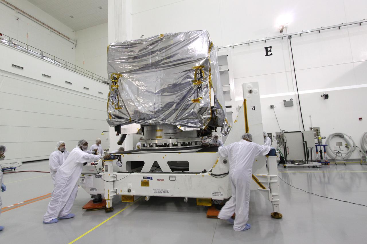 CAPE CANAVERAL, Fla. – At the Astrotech Space Operations facility in Titusville, Fla., workers move NASA's GOES-P meteorological satellite, covered in a protective bag and secured on a Ransome table, into position in a test cell where it will be rotated for further testing. GOES-P, the latest Geostationary Operational Environmental Satellite, was developed by NASA for the National Oceanic and Atmospheric Administration, or NOAA. GOES-P is designed to watch for storm development and observed current weather conditions on Earth. Launch of GOES-P is targeted for no earlier than Feb. 25, 2010, from Launch Complex 37 aboard a United Launch Alliance Delta IV rocket. For information on GOES-P, visit http://goespoes.gsfc.nasa.gov/goes/spacecraft/n_p_spacecraft.html. Photo credit: NASA/Jack Pfaller