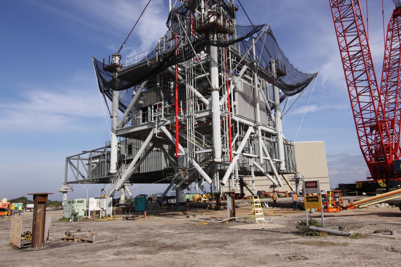 CAPE CANAVERAL, Fla. – At NASA's Kennedy Space Center in Florida, the seventh tower segment of a new mobile launcher, or ML, being constructed to support the Constellation Program, is lifted above the heads of the workers monitoring its ascent to the top of the growing tower. When completed, the tower will be approximately 345 feet tall and have multiple platforms for personnel access. The construction is under way at the mobile launcher park site area north of Kennedy's Vehicle Assembly Building. The launcher will provide a base to launch the Ares I rocket, designed to transport the Orion crew exploration vehicle, its crew and cargo to low Earth orbit. Its base is being made lighter than space shuttle mobile launcher platforms so the crawler-transporter can pick up the heavier load of the tower and taller rocket. For information on the Ares I, visit http://www.nasa.gov/ares. Photo credit: NASA/Jack Pfaller