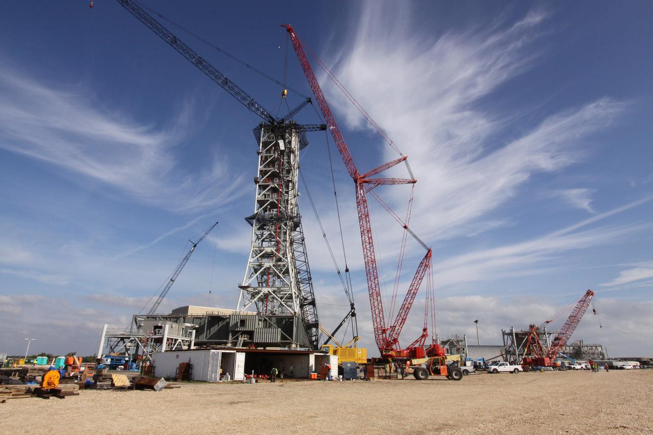 CAPE CANAVERAL, Fla. – At NASA's Kennedy Space Center in Florida, progress on the construction of the tower on a new mobile launcher, or ML, for the Constellation Program is apparent as the seventh tower segment is balanced in position. When completed, the tower will be approximately 345 feet tall and have multiple platforms for personnel access. The construction is under way at the mobile launcher park site area north of Kennedy's Vehicle Assembly Building. The launcher will provide a base to launch the Ares I rocket, designed to transport the Orion crew exploration vehicle, its crew and cargo to low Earth orbit. Its base is being made lighter than space shuttle mobile launcher platforms so the crawler-transporter can pick up the heavier load of the tower and taller rocket. For information on the Ares I, visit http://www.nasa.gov/ares. Photo credit: NASA/Jack Pfaller