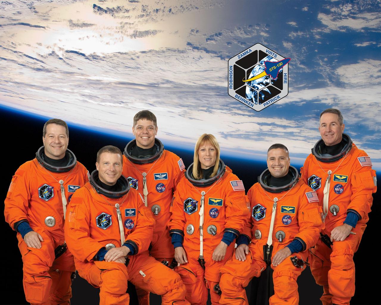 JOHNSON SPACE CENTER, Houston - STS130-S-002 - Attired in training versions of their shuttle launch and entry suits, these six astronauts take a break from training to pose for the STS-130 crew portrait. Seated are astronauts George Zamka (right), commander; and Terry Virts, pilot. From the left (standing) are astronaut Nicholas Patrick, Robert Behnken, Kathryn Hire and Stephen Robinson, all mission specialists.