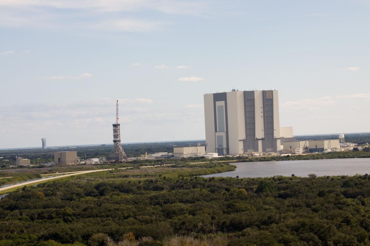 CAPE CANAVERAL, Fla. – At NASA's Kennedy Space Center in Florida, this aerial view of the mobile launcher park site area shows a new mobile launcher, or ML, for the Constellation Program under construction.  In the background at left is Launch Complex 41 on Cape Canaveral Air Force Station from which Atlas V rockets are launched.    When completed, the tower will be approximately 345 feet tall and have multiple platforms for personnel access. Its base is being made lighter than space shuttle mobile launcher platforms so the crawler-transporter can pick up the heavier load of the tower and a taller rocket.  For information on the Constellation Program, visit http://www.nasa.gov/constellation. Photo credit: NASA/Cory Huston