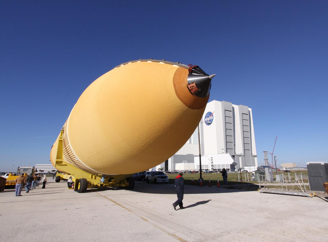 CAPE CANAVERAL, Fla. – At NASA's Kennedy Space Center in Florida, workers inspect External Tank-135, newly offloaded from the Pegasus barge docked in the turn basin near the Vehicle Assembly Building. Pegasus arrived in Florida on Dec. 26, towed by a solid rocket booster retrieval ship from NASA's Michoud Assembly Facility near New Orleans. ET-135 will be used to launch space shuttle Discovery on the STS-131 mission to the International Space Station. Launch is targeted for March 18. For information on the components of the space shuttle and the STS-131 mission, visit http://www.nasa.gov/mission_pages/shuttle/shuttlemissions/sts131/index.html. Photo credit: NASA/Jack Pfaller