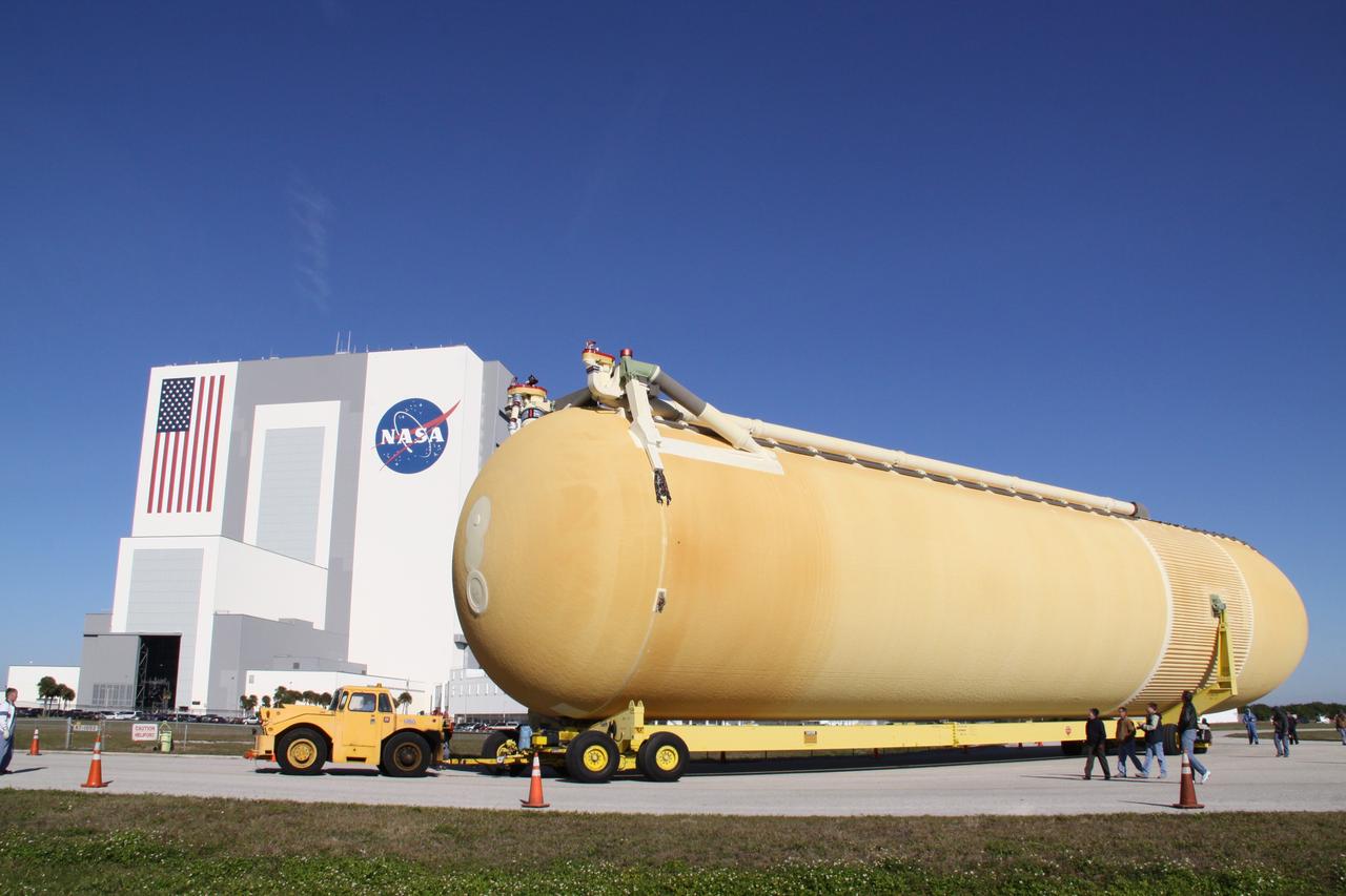 CAPE CANAVERAL, Fla. – At NASA's Kennedy Space Center in Florida, External Tank-135 is transported to the Vehicle Assembly Building in the background. The tank arrived in Florida on Dec. 26 aboard the Pegasus barge, towed by a solid rocket booster retrieval ship from NASA's Michoud Assembly Facility near New Orleans. ET-135 will be used to launch space shuttle Discovery on the STS-131 mission to the International Space Station. Launch is targeted for March 18. For information on the components of the space shuttle and the STS-131 mission, visit http://www.nasa.gov/mission_pages/shuttle/shuttlemissions/sts131/index.html. Photo credit: NASA/Jack Pfaller