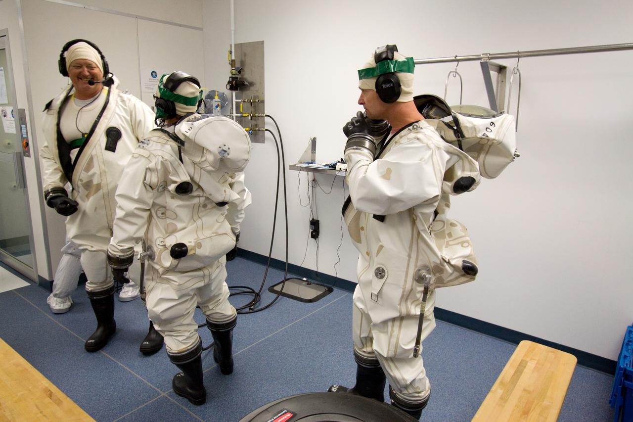 CAPE CANAVERAL, Fla. – At the Astrotech Space Operations facility in Titusville, Fla., spacecraft fueling technicians from Kennedy Space Center prepare to sample the monomethylhydrazine propellant that will be loaded aboard the Solar Dynamics Observatory, or SDO.  From left are Boeing technicians Richard Gillman and Steve Lay, and SDO technician Brian Kittle.    The hydrazine fuel is being sampled for purity before it is loaded aboard the spacecraft.  The technicians are dressed in self-contained atmospheric protective ensemble suits, or SCAPE suits, as a safety precaution in the unlikely event that any of the highly toxic chemical should escape from the storage tank. The nitrogen tetroxide oxidizer was loaded earlier in the week which is customarily followed by loading of the fuel.  Propellant loading is one of the final processing milestones before the spacecraft is encapsulated in its fairing for launch.  SDO is the first mission in NASA's Living With a Star Program and is designed to study the causes of solar variability and its impacts on Earth. The spacecraft's long-term measurements will give solar scientists in-depth information to help characterize the interior of the Sun, the Sun's magnetic field, the hot plasma of the solar corona, and the density of radiation that creates the ionosphere of the planets. The information will be used to create better forecasts of space weather needed to protect the aircraft, satellites and astronauts living and working in space. Liftoff aboard an Atlas V rocket is targeted for Feb. 9 from Launch Complex 41 on Cape Canaveral Air Force Station. For information on SDO, visit http://www.nasa.gov/sdo.  Photo credit: NASA/Jack Pfaller