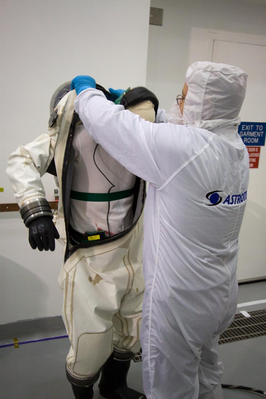 CAPE CANAVERAL, Fla. – At the Astrotech Space Operations facility in Titusville, Fla., spacecraft fueling technicians from Kennedy Space Center prepare to sample the monomethylhydrazine propellant that will be loaded aboard the Solar Dynamics Observatory, or SDO.  From left are Boeing technician Steve Lay and ASTROTECH mission/facility manager Gerard Gleeson.    The hydrazine fuel is being sampled for purity before it is loaded aboard the spacecraft.  The technicians are dressed in self-contained atmospheric protective ensemble suits, or SCAPE suits, as a safety precaution in the unlikely event that any of the highly toxic chemical should escape from the storage tank. The nitrogen tetroxide oxidizer was loaded earlier in the week which is customarily followed by loading of the fuel.  Propellant loading is one of the final processing milestones before the spacecraft is encapsulated in its fairing for launch.  SDO is the first mission in NASA's Living With a Star Program and is designed to study the causes of solar variability and its impacts on Earth. The spacecraft's long-term measurements will give solar scientists in-depth information to help characterize the interior of the Sun, the Sun's magnetic field, the hot plasma of the solar corona, and the density of radiation that creates the ionosphere of the planets. The information will be used to create better forecasts of space weather needed to protect the aircraft, satellites and astronauts living and working in space. Liftoff aboard an Atlas V rocket is targeted for Feb. 9 from Launch Complex 41 on Cape Canaveral Air Force Station. For information on SDO, visit http://www.nasa.gov/sdo.  Photo credit: NASA/Jack Pfaller