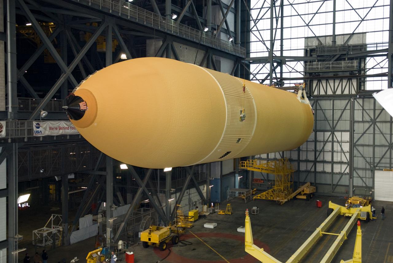 CAPE CANAVERAL, Fla. – In the transfer aisle of the Vehicle Assembly Building at NASA's Kennedy Space Center in Florida, a crane lifts the external fuel tank for space shuttle Discovery's STS-131 mission, ET-135, from its transporter toward a test cell. The tank was delivered to Kennedy aboard the Pegasus barge from NASA's Michoud Assembly Facility on Dec. 26. The tank will remain in the test cell until it is transferred into a high bay for mating with the twin solid rocket boosters that will be used on the mission. Launch of the STS-131 mission to the International Space Station is targeted for March 18. For information on the STS-131 mission and crew, visit http://www.nasa.gov/mission_pages/shuttle/shuttlemissions/sts131/index.html. Photo credit: NASA/Glenn Benson