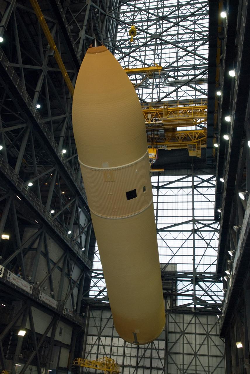 CAPE CANAVERAL, Fla. – In the transfer aisle of the Vehicle Assembly Building at NASA's Kennedy Space Center in Florida, the external fuel tank for space shuttle Discovery's STS-131 mission, ET-135, is rotated into a vertical position as it is lifted toward a test cell. The tank was delivered to Kennedy aboard the Pegasus barge from NASA's Michoud Assembly Facility on Dec. 26. The tank will remain in the test cell until it is transferred into a high bay for mating with the twin solid rocket boosters that will be used on the mission. Launch of the STS-131 mission to the International Space Station is targeted for March 18. For information on the STS-131 mission and crew, visit http://www.nasa.gov/mission_pages/shuttle/shuttlemissions/sts131/index.html. Photo credit: NASA/Glenn Benson