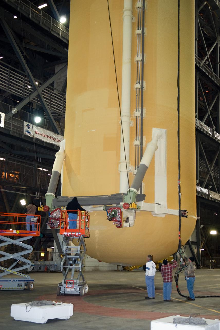CAPE CANAVERAL, Fla. – In the Vehicle Assembly Building at NASA's Kennedy Space Center in Florida, workers prepare the external fuel tank for space shuttle Discovery's STS-131 mission, ET-135, hanging vertically in the transfer aisle, for its lift into a test cell. The tank was delivered to Kennedy aboard the Pegasus barge from NASA's Michoud Assembly Facility on Dec. 26. The tank will remain in the test cell until it is transferred into a high bay for mating with the twin solid rocket boosters that will be used on the mission. Launch of the STS-131 mission to the International Space Station is targeted for March 18. For information on the STS-131 mission and crew, visit http://www.nasa.gov/mission_pages/shuttle/shuttlemissions/sts131/index.html. Photo credit: NASA/Glenn Benson