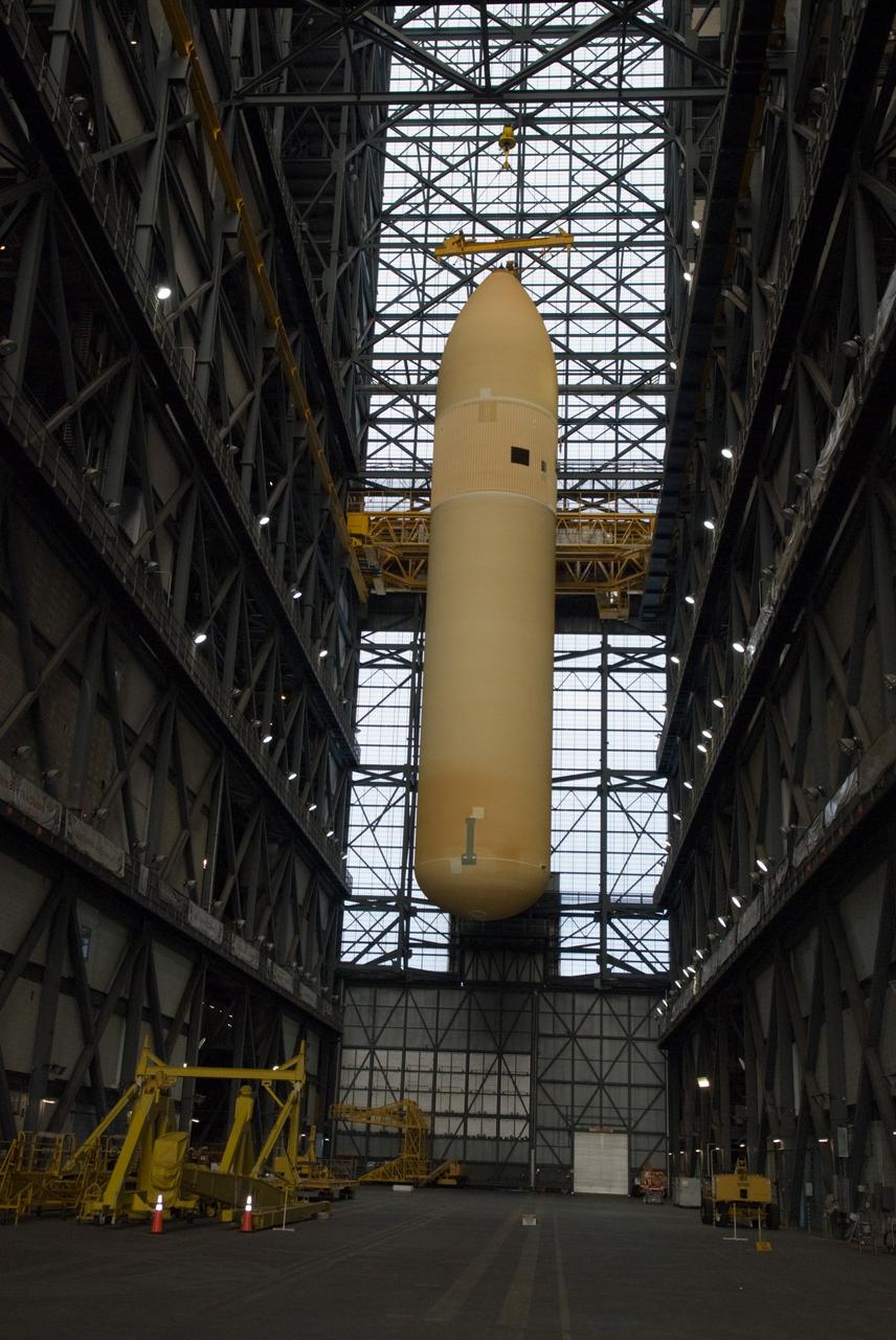CAPE CANAVERAL, Fla. – In the Vehicle Assembly Building at NASA's Kennedy Space Center in Florida, the external fuel tank for space shuttle Discovery's STS-131 mission, ET-135, is lifted above the transfer aisle for transfer into a test cell. The tank was delivered to Kennedy aboard the Pegasus barge from NASA's Michoud Assembly Facility on Dec. 26. The tank will remain in the test cell until it is transferred into a high bay for mating with the twin solid rocket boosters that will be used on the mission. Launch of the STS-131 mission to the International Space Station is targeted for March 18. For information on the STS-131 mission and crew, visit http://www.nasa.gov/mission_pages/shuttle/shuttlemissions/sts131/index.html. Photo credit: NASA/Glenn Benson