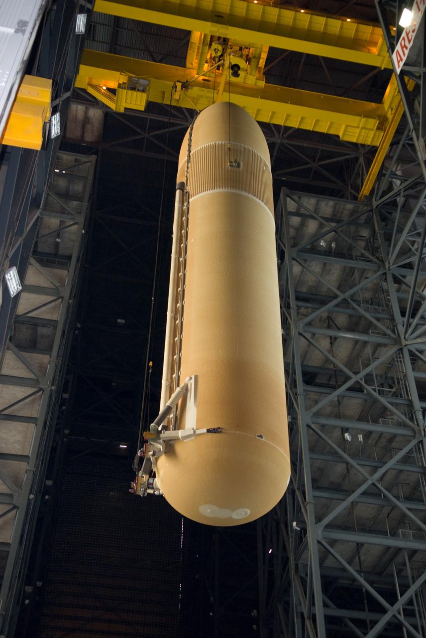 CAPE CANAVERAL, Fla. – In the Vehicle Assembly Building at NASA's Kennedy Space Center in Florida, a crane is enlisted to lift the external fuel tank for space shuttle Discovery's STS-131 mission, ET-135, into a test cell. The tank was delivered to Kennedy aboard the Pegasus barge from NASA's Michoud Assembly Facility on Dec. 26. The tank will remain in the test cell until it is transferred into a high bay for mating with the twin solid rocket boosters that will be used on the mission. Launch of the STS-131 mission to the International Space Station is targeted for March 18. For information on the STS-131 mission and crew, visit http://www.nasa.gov/mission_pages/shuttle/shuttlemissions/sts131/index.html. Photo credit: NASA/Glenn Benson