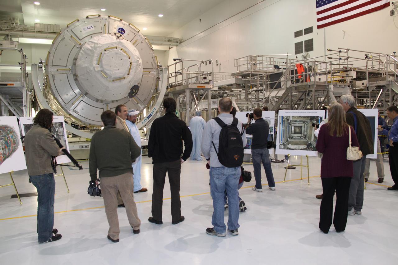 CAPE CANAVERAL, Fla. – In the Space Station Processing Facility at NASA's Kennedy Space Center in Florida, media representatives view the International Space Station's Node 3, named Tranquility.    The primary payload for the STS-130 mission, Tranquility is a pressurized module that will provide room for many of the space station's life support systems. Attached to one end of Tranquility is a cupola, a unique work area with six windows on its sides and one on top.  The cupola resembles a circular bay window and will provide a vastly improved view of the station's exterior. The multi-directional view will allow the crew to monitor spacewalks and docking operations, as well as provide a spectacular view of Earth and other celestial objects. The module was built in Turin, Italy, by Thales Alenia Space for the European Space Agency.  Space shuttle Endeavour's STS-130 mission is targeted for launch in early February 2010. For information on the STS-130 mission and crew, visit http://www.nasa.gov/mission_pages/shuttle/shuttlemissions/sts130/index.html.  Photo credit: NASA/Jack Pfaller