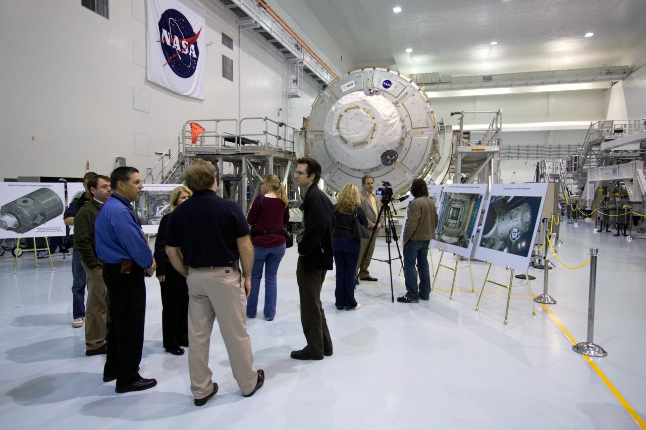CAPE CANAVERAL, Fla. – In the Space Station Processing Facility at NASA's Kennedy Space Center in Florida, media representatives gather to view the International Space Station's Node 3, named Tranquility.    The primary payload for the STS-130 mission, Tranquility is a pressurized module that will provide room for many of the space station's life support systems. Attached to one end of Tranquility is a cupola, a unique work area with six windows on its sides and one on top.  The cupola resembles a circular bay window and will provide a vastly improved view of the station's exterior. The multi-directional view will allow the crew to monitor spacewalks and docking operations, as well as provide a spectacular view of Earth and other celestial objects. The module was built in Turin, Italy, by Thales Alenia Space for the European Space Agency.  Space shuttle Endeavour's STS-130 mission is targeted for launch in early February 2010. For information on the STS-130 mission and crew, visit http://www.nasa.gov/mission_pages/shuttle/shuttlemissions/sts130/index.html.  Photo credit: NASA/Jack Pfaller