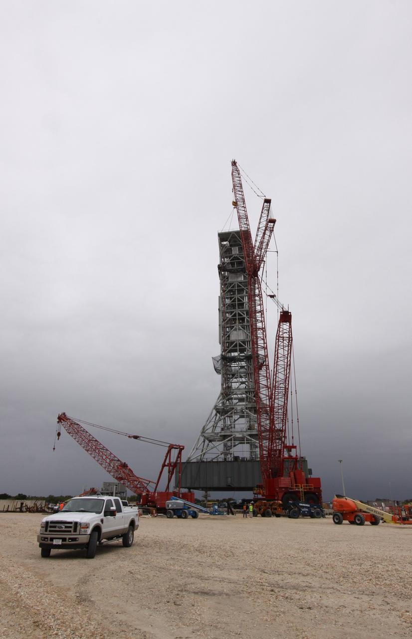CAPE CANAVERAL, Fla. – At NASA's Kennedy Space Center in Florida, construction of the tower on a new mobile launcher, or ML, for the Constellation Program progresses with placement of the eighth tower segment on the growing structure. When completed, the tower will be approximately 345 feet tall and have multiple platforms for personnel access. The construction is under way at the mobile launcher park site area north of Kennedy's Vehicle Assembly Building. The launcher will provide a base to launch the Ares I rocket, designed to transport the Orion crew exploration vehicle, its crew and cargo to low Earth orbit. Its base is being made lighter than space shuttle mobile launcher platforms so the crawler-transporter can pick up the heavier load of the tower and taller rocket. For information on the Ares I, visit http://www.nasa.gov/ares. Photo credit: NASA/Jack Pfaller