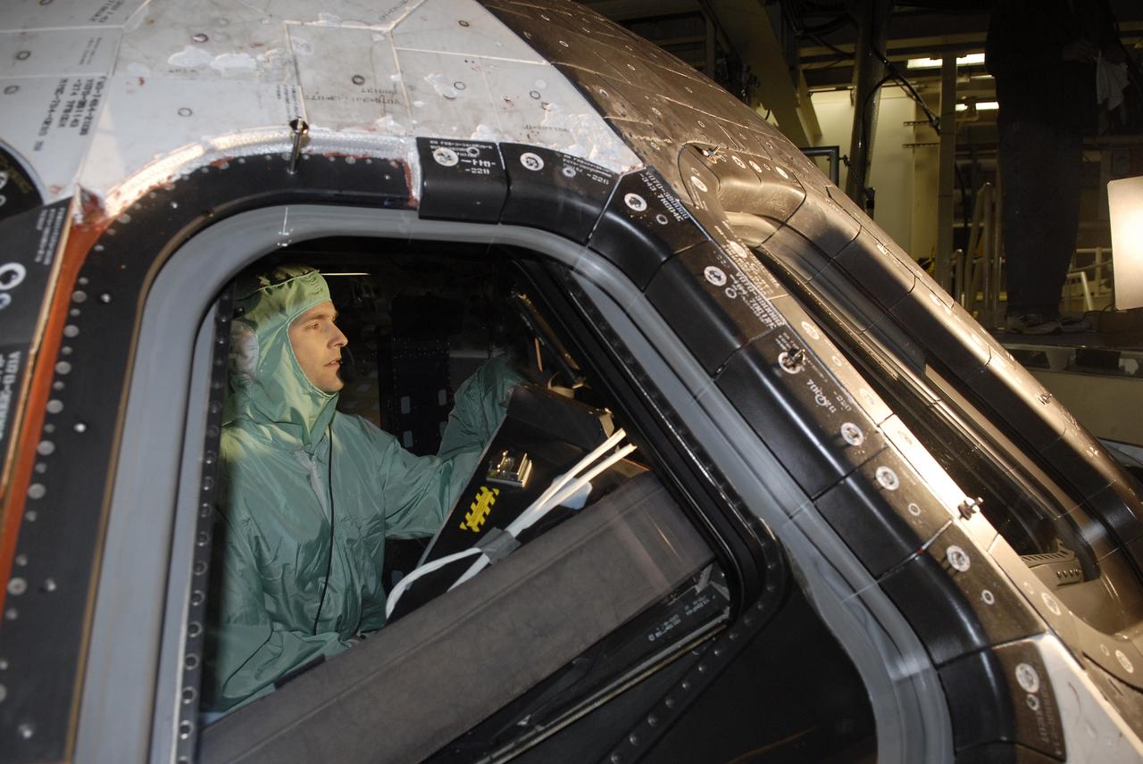 CAPE CANAVERAL, Fla. - In Orbiter Processing Facility 3 at NASA's Kennedy Space Center in Florida, members of space shuttle Discovery's STS-131 crew participate in training activities during the Crew Equipment Interface Test, or CEIT, for their mission.  Here, Pilot James P. Dutton Jr. experiences the view through Discovery's windows from a vantage point in the cockpit.    The CEIT provides the crew with hands-on training and observation of shuttle and flight hardware. The seven-member crew will deliver the multi-purpose logistics module Leonardo, filled with resupply stowage platforms and racks to be transferred to locations around the International Space Station.  Three spacewalks will include work to attach a spare ammonia tank assembly to the station's exterior and return a European experiment from outside the station's Columbus module.  Discovery's launch is targeted for March 18.  For information on the STS-131 mission and crew, visit http://www.nasa.gov/mission_pages/shuttle/shuttlemissions/sts131/index.html.  Photo credit: NASA/Kim Shiflett