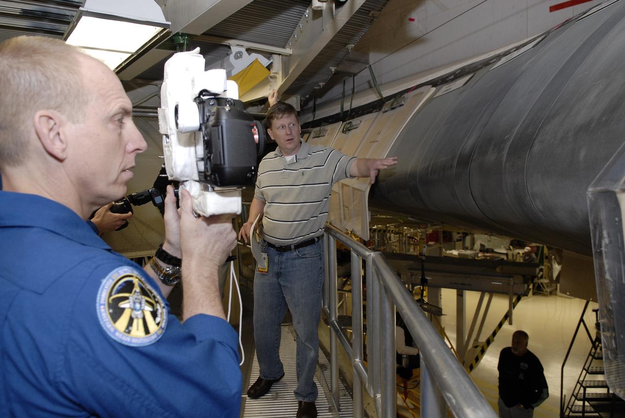 CAPE CANAVERAL, Fla. - In Orbiter Processing Facility 3 at NASA's Kennedy Space Center in Florida, members of space shuttle Discovery's STS-131 crew participate in training activities during the Crew Equipment Interface Test, or CEIT, for their mission. Here, Mission Specialist Clay Anderson is given the opportunity to operate one of the cameras that will be used to photograph the reinforced carbon carbon panels during his mission. The panels are part of the shuttle's thermal protection system. The CEIT provides the crew with hands-on training and observation of shuttle and flight hardware. The seven-member crew will deliver the multi-purpose logistics module Leonardo, filled with resupply stowage platforms and racks to be transferred to locations around the International Space Station. Three spacewalks will include work to attach a spare ammonia tank assembly to the station's exterior and return a European experiment from outside the station's Columbus module. Discovery's launch is targeted for March 18. For information on the STS-131 mission and crew, visit http://www.nasa.gov/mission_pages/shuttle/shuttlemissions/sts131/index.html. Photo credit: NASA/Kim Shiflett
