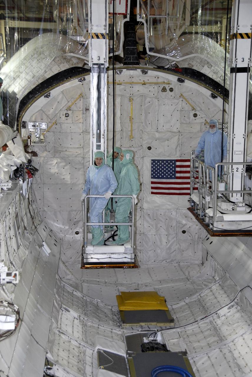 CAPE CANAVERAL, Fla. - In Orbiter Processing Facility 3 at NASA's Kennedy Space Center in Florida, members of space shuttle Discovery's STS-131 crew participate in training activities during the Crew Equipment Interface Test, or CEIT, for their mission.  Here, buckets are used to lower the crew members and their trainers into Discovery's payload bay without damaging the bay's lining.    The CEIT provides the crew with hands-on training and observation of shuttle and flight hardware. The seven-member crew will deliver the multi-purpose logistics module Leonardo, filled with resupply stowage platforms and racks to be transferred to locations around the International Space Station.  Three spacewalks will include work to attach a spare ammonia tank assembly to the station's exterior and return a European experiment from outside the station's Columbus module.  Discovery's launch is targeted for March 18.  For information on the STS-131 mission and crew, visit http://www.nasa.gov/mission_pages/shuttle/shuttlemissions/sts131/index.html.  Photo credit: NASA/Kim Shiflett