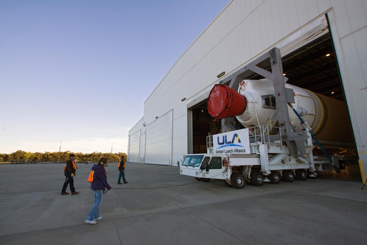 CAPE CANAVERAL, Fla. – In the Horizontal Integration Facility at Launch Complex 37 on Cape Canaveral Air Force Station in Florida, workers act as spotters for the driver of a transporter moving the core stage of a Delta IV rocket out of the facility to the pad. The rocket's core stage is the first stage mated to the second stage. This United Launch Alliance Delta IV rocket is slated to launch GOES-P, the latest Geostationary Operational Environmental Satellite developed by NASA for the National Oceanic and Atmospheric Administration, or NOAA. Launch is targeted for no earlier than March 1. For information on GOES-P, visit http://goespoes.gsfc.nasa.gov/goes/spacecraft/n_p_spacecraft.html. Photo credit: NASA/Jack Pfaller