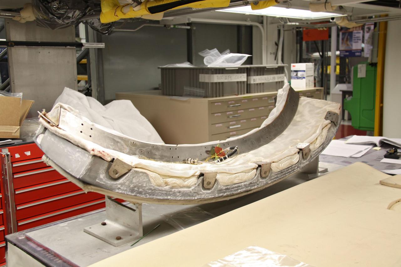 CAPE CANAVERAL, Fla. - In Orbiter Processing Facility 1 at NASA's Kennedy Space Center in Florida, preparations are under way to install the chin panel on space shuttle Atlantis.    The chin panel is a semicircular-shaped section of reinforced carbon-carbon that fits under the shuttle's nose cap and is part of its thermal protection system.  Atlantis is next slated to deliver an Integrated Cargo Carrier and Russian-built Mini Research Module to the International Space Station on the STS-132 mission. The second in a series of new pressurized components for Russia, the module will be permanently attached to the Zarya module. Three spacewalks are planned to store spare components outside the station, including six spare batteries, a boom assembly for the Ku-band antenna and spares for the Canadian Dextre robotic arm extension. A radiator, airlock and European robotic arm for the Russian Multi-purpose Laboratory Module also are payloads on the flight.  Launch is targeted for May 14, 2010.    Photo credit: NASA/Troy Cryder