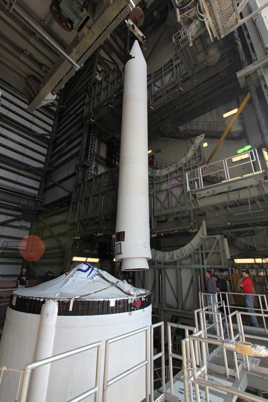 CAPE CANAVERAL, Fla. – At Launch Complex 37 on Cape Canaveral Air Force Station in Florida, a solid rocket booster for the Delta IV rocket slated to launch NASA's GOES-P meteorological satellite is lowered toward the rocket in the mobile service tower.    GOES-P is the latest Geostationary Operational Environmental Satellite developed by NASA for the National Oceanic and Atmospheric Administration, or NOAA. The Delta IV rocket will be launched by United Launch Alliance for Boeing Launch Services under an FAA commercial license.  Launch is targeted for no earlier than March 1.  For information on GOES-P, visit http://goespoes.gsfc.nasa.gov/goes/spacecraft/n_p_spacecraft.html. Photo credit: NASA/Jack Pfaller