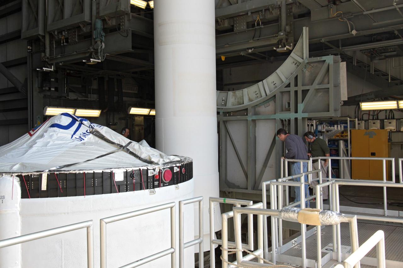 CAPE CANAVERAL, Fla. – In the mobile service tower at Launch Complex 37 on Cape Canaveral Air Force Station in Florida, workers monitor a solid rocket booster for the Delta IV rocket slated to launch NASA's GOES-P meteorological satellite as it is lowered beside the rocket.    GOES-P is the latest Geostationary Operational Environmental Satellite developed by NASA for the National Oceanic and Atmospheric Administration, or NOAA. The Delta IV rocket will be launched by United Launch Alliance for Boeing Launch Services under an FAA commercial license.  Launch is targeted for no earlier than March 1.  For information on GOES-P, visit http://goespoes.gsfc.nasa.gov/goes/spacecraft/n_p_spacecraft.html. Photo credit: NASA/Jack Pfaller