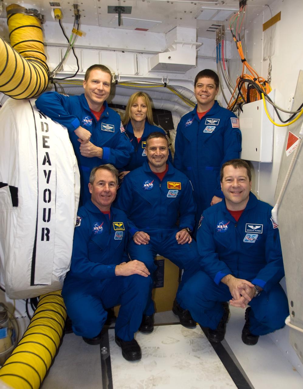 CAPE CANAVERAL, Fla. - At NASA's Kennedy Space Center in Florida, the crew members of space shuttle Endeavour's STS-130 mission take time out from their emergency exit training at Launch Pad 39A to pose for a group portrait in the White Room. Standing, from left, are Pilot Terry Virts and Mission Specialists Kathryn Hire and Robert Behnken.  Kneeling, from left, are Mission Specialist Stephen Robinson, Commander George Zamka and Mission Specialist Nicholas Patrick.    The crew members of space shuttle Endeavour's upcoming mission are at Kennedy for training related to their launch dress rehearsal, the Terminal Countdown Demonstration Test.  The primary payload on STS-130 is the International Space Station's Node 3, Tranquility, a pressurized module that will provide room for many of the station's life support systems. Attached to one end of Tranquility is a cupola, a unique work area with six windows on its sides and one on top.  Endeavour's launch is targeted for Feb. 7.  For information on the STS-130 mission and crew, visit http://www.nasa.gov/mission_pages/shuttle/shuttlemissions/sts130/index.html.  Photo credit: NASA/Kim Shiflett