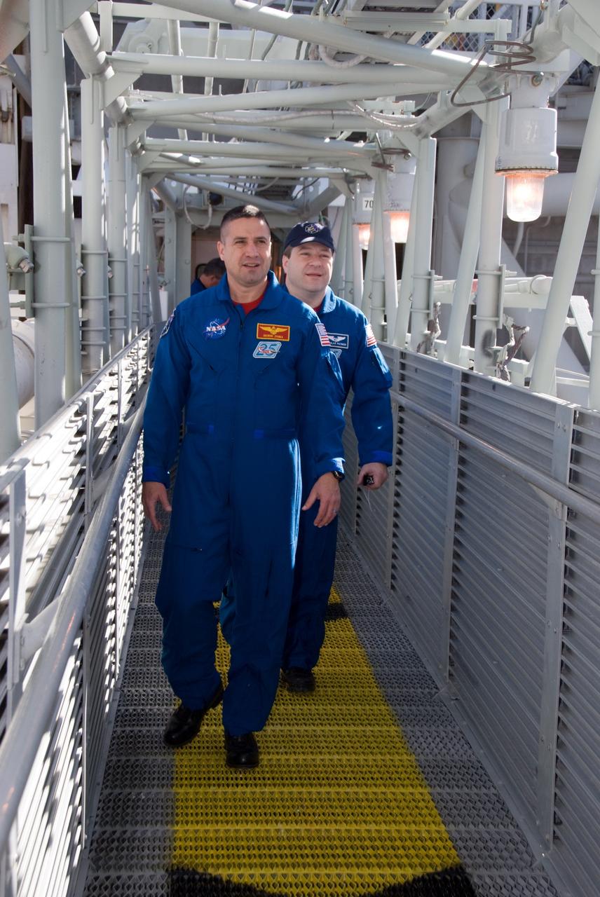 CAPE CANAVERAL, Fla. - On Launch Pad 39A at NASA's Kennedy Space Center in Florida, STS-130 Commander George Zamka, front, and Mission Specialist Nicholas Patrick travel the route from the White Room that they would take if an emergency exit from the pad were required. The crew members of space shuttle Endeavour's upcoming mission are at Kennedy for training related to their launch dress rehearsal, the Terminal Countdown Demonstration Test. The primary payload on STS-130 is the International Space Station's Node 3, Tranquility, a pressurized module that will provide room for many of the station's life support systems. Attached to one end of Tranquility is a cupola, a unique work area with six windows on its sides and one on top. Endeavour's launch is targeted for Feb. 7. For information on the STS-130 mission and crew, visit http://www.nasa.gov/mission_pages/shuttle/shuttlemissions/sts130/index.html. Photo credit: NASA/Kim Shiflett