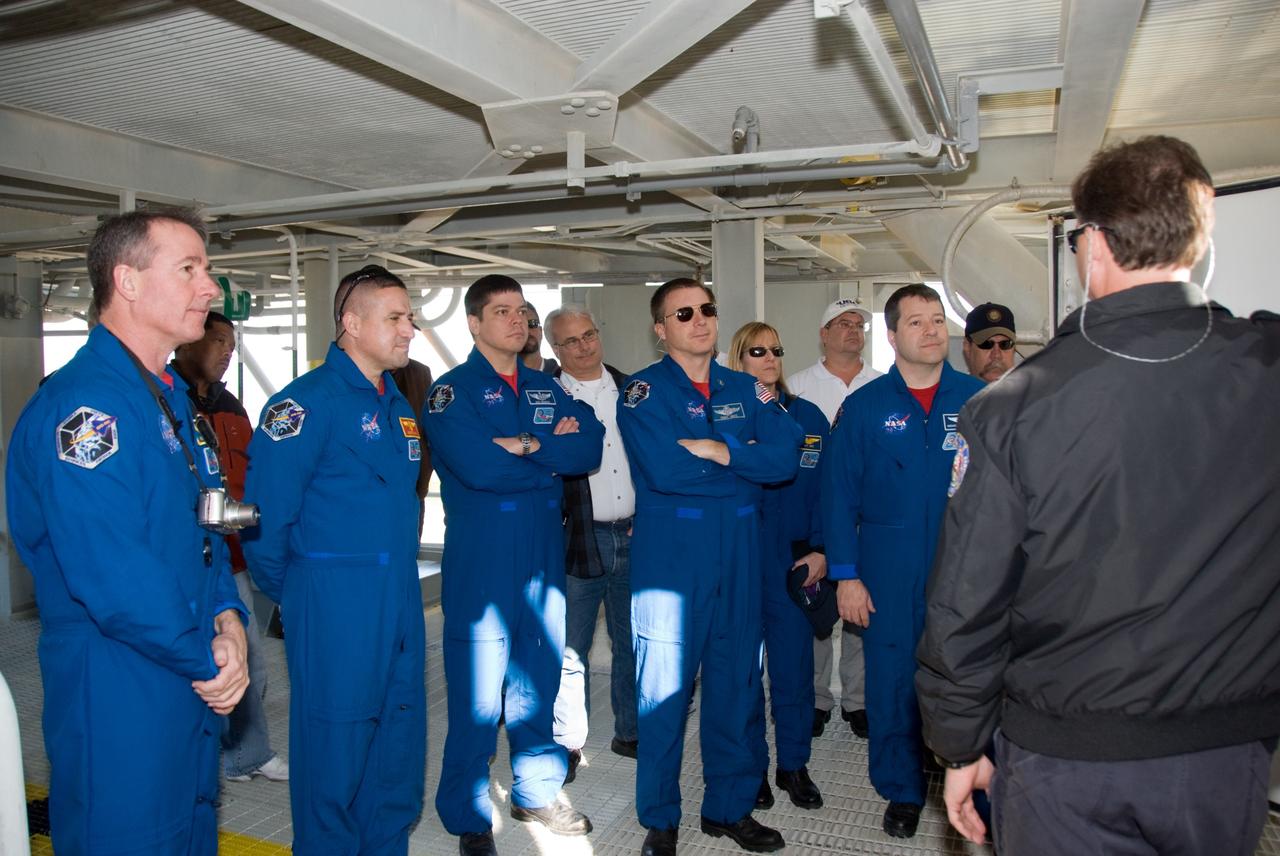 CAPE CANAVERAL, Fla. - On Launch Pad 39A at NASA's Kennedy Space Center in Florida, the members of space shuttle Endeavour's STS-130 crew are instructed on emergency exit procedures. From left are Mission Specialist Stephen Robinson; Commander George Zamka; Mission Specialist Robert Behnken; Pilot Terry Virts; and Mission Specialists Kathryn Hire and Nicholas Patrick. The crew members of space shuttle Endeavour's upcoming mission are at Kennedy for training related to their launch dress rehearsal, the Terminal Countdown Demonstration Test. The primary payload on STS-130 is the International Space Station's Node 3, Tranquility, a pressurized module that will provide room for many of the station's life support systems. Attached to one end of Tranquility is a cupola, a unique work area with six windows on its sides and one on top. Endeavour's launch is targeted for Feb. 7. For information on the STS-130 mission and crew, visit http://www.nasa.gov/mission_pages/shuttle/shuttlemissions/sts130/index.html. Photo credit: NASA/Kim Shiflett