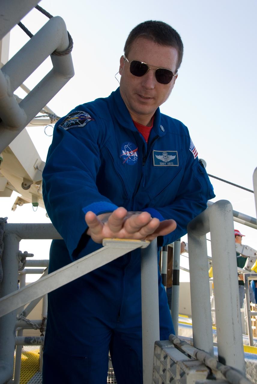 CAPE CANAVERAL, Fla. - On Launch Pad 39A at NASA's Kennedy Space Center in Florida, STS-130 Pilot Terry Virts familiarizes himself with the release mechanism of a slidewire basket during training on the emergency exit system at the pad. The system includes seven baskets suspended from seven slidewires that extend from the fixed service structure to a landing zone 1,200 feet west of the pad. The crew members of space shuttle Endeavour's upcoming mission are at Kennedy for training related to their launch dress rehearsal, the Terminal Countdown Demonstration Test. The primary payload on STS-130 is the International Space Station's Node 3, Tranquility, a pressurized module that will provide room for many of the station's life support systems. Attached to one end of Tranquility is a cupola, a unique work area with six windows on its sides and one on top. Endeavour's launch is targeted for Feb. 7. For information on the STS-130 mission and crew, visit http://www.nasa.gov/mission_pages/shuttle/shuttlemissions/sts130/index.html. Photo credit: NASA/Kim Shiflett