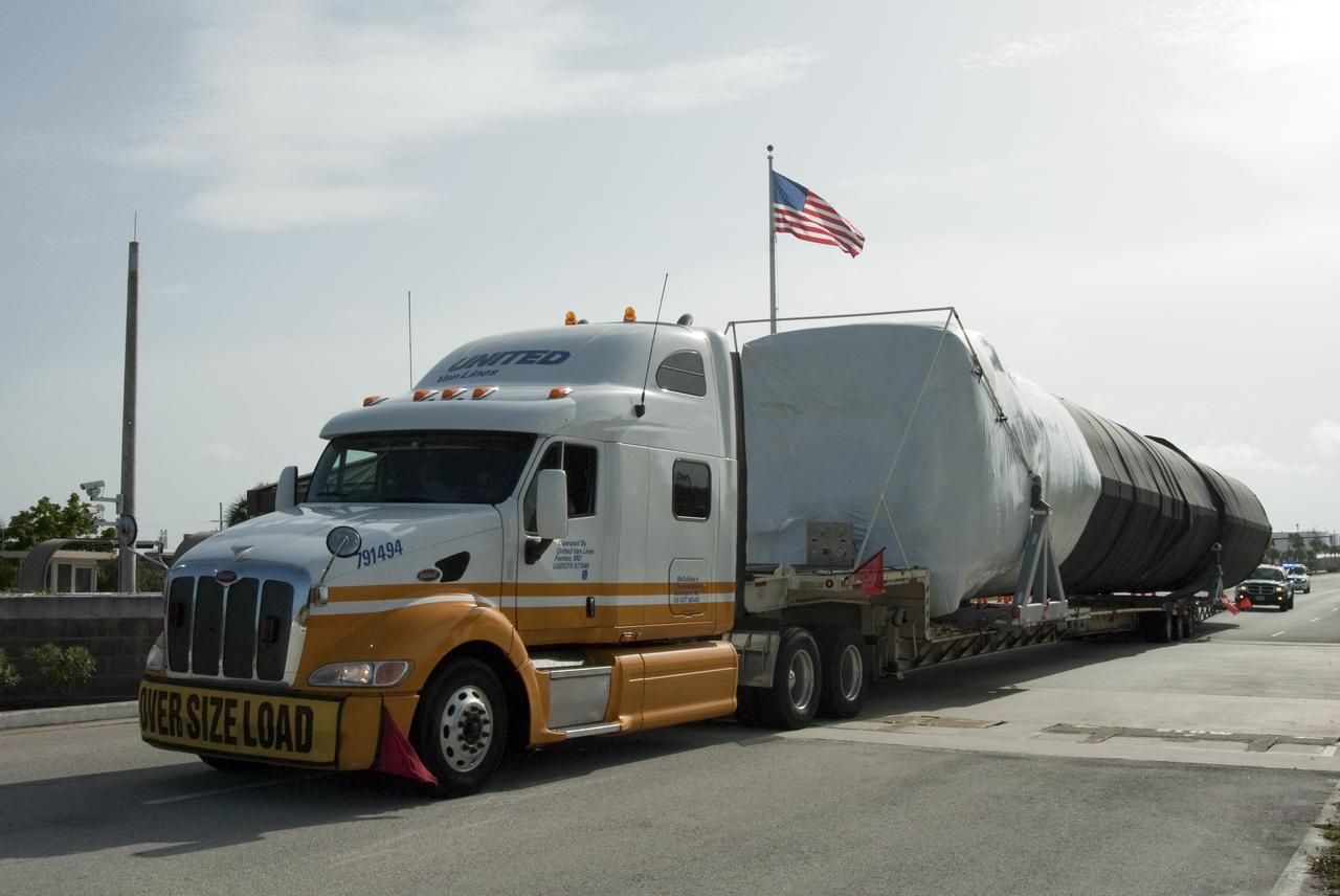 CAPE CANAVERAL, Fla. -- The first stage of the SpaceX Falcon 9 rocket arrives at Cape Canaveral Air Force Station in Florida. Once assembled, it will be a two-stage fully integrated launch vehicle, consisting of a first stage powered by nine SpaceX-developed Merlin 1C engines, a second stage, an interstage, an unpressurized trunk and the Dragon spacecraft qualification unit. SpaceX was awarded procurement for three demonstration flights under the Commercial Orbital Transportation Services, or COTS, program managed by NASA's Johnson Space Center in Houston. A subsequent contract for Commercial Resupply Services, or CRS, was awarded in late 2008 to resupply the International Space Station. The SpaceX CRS contract provides for 12 missions to resupply the station from 2011 through 2015. Photo credit: NASA/Chris Rhodes