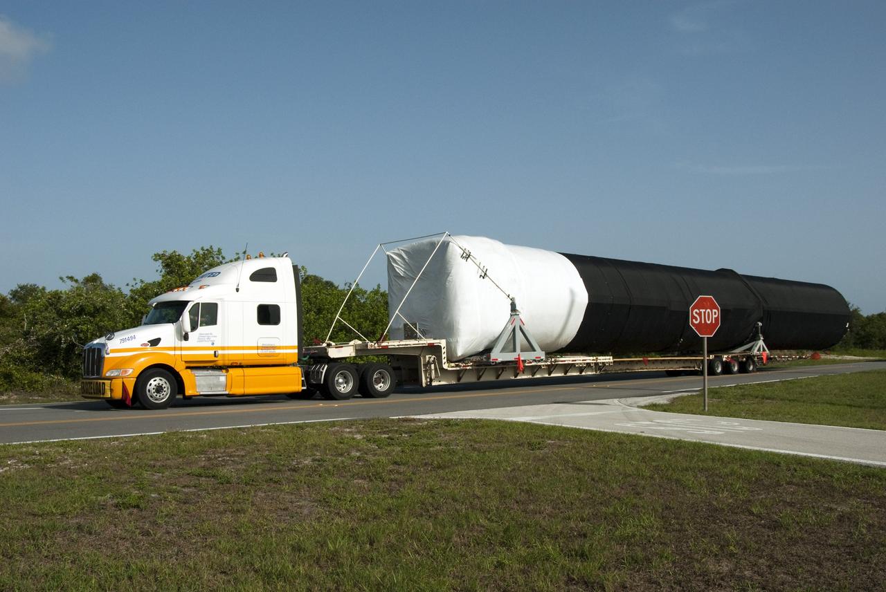 CAPE CANAVERAL, Fla. -- The first stage of the SpaceX Falcon 9 rocket arrives at Cape Canaveral Air Force Station in Florida. Once assembled, it will be a two-stage fully integrated launch vehicle, consisting of a first stage powered by nine SpaceX-developed Merlin 1C engines, a second stage, an interstage, an unpressurized trunk and the Dragon spacecraft qualification unit. SpaceX was awarded procurement for three demonstration flights under the Commercial Orbital Transportation Services, or COTS, program managed by NASA's Johnson Space Center in Houston. A subsequent contract for Commercial Resupply Services, or CRS, was awarded in late 2008 to resupply the International Space Station. The SpaceX CRS contract provides for 12 missions to resupply the station from 2011 through 2015. Photo credit: NASA/Chris Rhodes