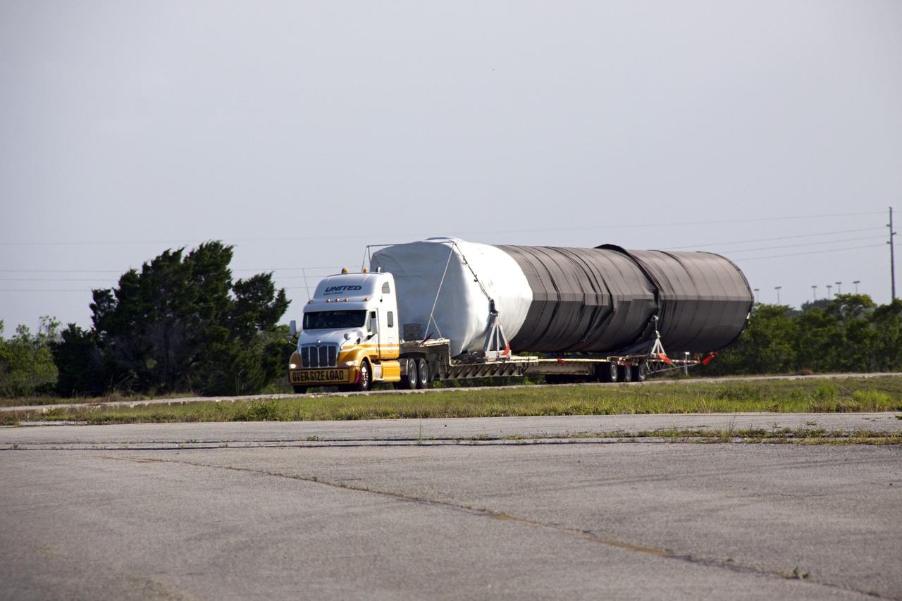 CAPE CANAVERAL, Fla. -- The first stage of the SpaceX Falcon 9 rocket arrives at Launch Complex-40 at Cape Canaveral Air Force Station in Florida. Once assembled, it will be a two-stage fully integrated launch vehicle, consisting of a first stage powered by nine SpaceX-developed Merlin 1C engines, a second stage, an interstage, an unpressurized trunk and the Dragon spacecraft qualification unit. SpaceX was awarded procurement for three demonstration flights under the Commercial Orbital Transportation Services, or COTS, program managed by NASA's Johnson Space Center in Houston. A subsequent contract for Commercial Resupply Services, or CRS, was awarded in late 2008 to resupply the International Space Station. The SpaceX CRS contract provides for 12 missions to resupply the station from 2011 through 2015. Photo credit: NASA/Troy Cryder