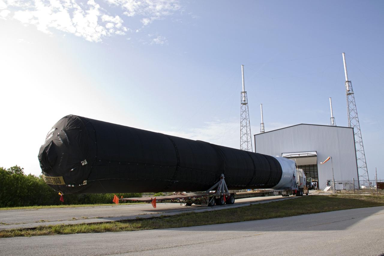 CAPE CANAVERAL, Fla. -- At Cape Canaveral Air Force Station in Florida, the first stage of the SpaceX Falcon 9 rocket arrives at Launch Complex-40's horizontal processing hangar. Once assembled, it will be a two-stage fully integrated launch vehicle, consisting of a first stage powered by nine SpaceX-developed Merlin 1C engines, a second stage, an interstage, an unpressurized trunk and the Dragon spacecraft qualification unit.          SpaceX was awarded procurement for three demonstration flights under the Commercial Orbital Transportation Services, or COTS, program managed by NASA's Johnson Space Center in Houston. A subsequent contract for Commercial Resupply Services, or CRS, was awarded in late 2008 to resupply the International Space Station. The SpaceX CRS contract provides for 12 missions to resupply the station from 2011 through 2015. Photo credit: NASA/Troy Cryder