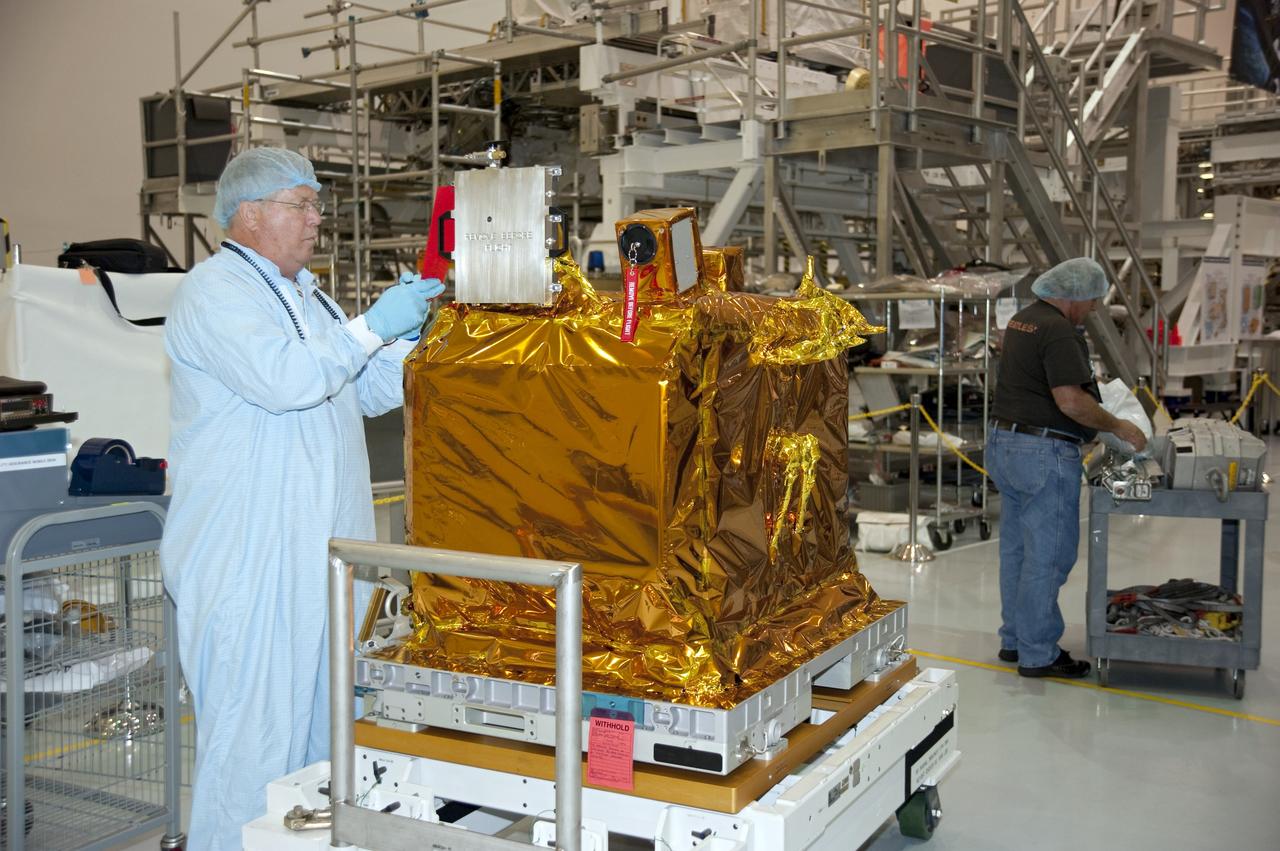 CAPE CANAVERAL, Fla. -- In the Space Station Processing Facility at NASA Kennedy Space Center in Florida, a technician finalizes quality assurance paperwork before the Space Test Program-Houston-3, or STP-H3, payload is installed onto the Express Logistics Carrier-3, or ELC-3.          STP-H3 is a compliment of four individual Department of Defense experiments that will test concepts in low earth orbit for long duration flights. As the final planned mission of the Space Shuttle Program, shuttle Endeavour and its STS-134 crew will deliver the Alpha Magnetic Spectrometer, the ELC-3 as well as critical spare components to the International Space Station. Endeavour is targeted for launch Feb. 26, 2011. For more information visit, http://www.nasa.gov/mission_pages/shuttle/shuttlemissions/sts134/index.html. Photo credit: NASA/Kim Shiflett