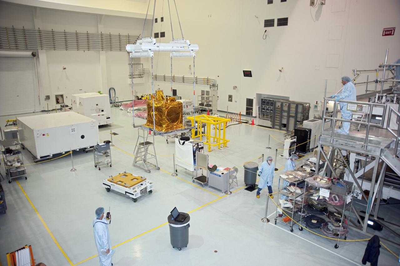 CAPE CANAVERAL, Fla. -- In the Space Station Processing Facility at NASA Kennedy Space Center in Florida, the lift ground support equipment transports the Space Test Program-Houston-3, or STP-H3, payload toward the Express Logistics Carrier-3, or ELC-3.          STP-H3 is a compliment of four individual Department of Defense experiments that will test concepts in low earth orbit for long duration flights. As the final planned mission of the Space Shuttle Program, shuttle Endeavour and its STS-134 crew will deliver the Alpha Magnetic Spectrometer, the ELC-3 as well as critical spare components to the International Space Station. Endeavour is targeted for launch Feb. 26, 2011. For more information visit, http://www.nasa.gov/mission_pages/shuttle/shuttlemissions/sts134/index.html. Photo credit: NASA/Kim Shiflett