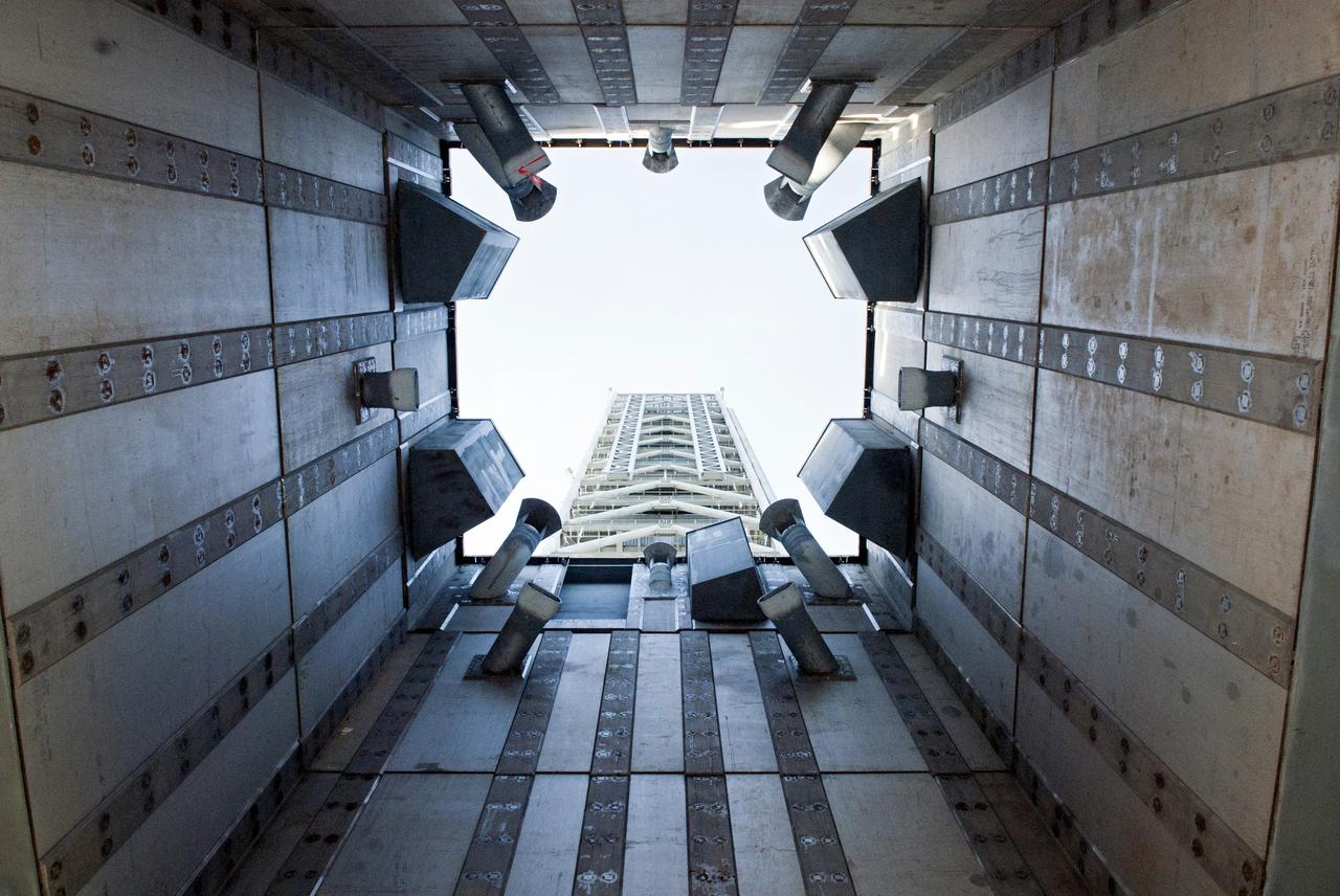 CAPE CANAVERAL, Fla. -- At NASA's Kennedy Space Center in Florida, the tower of NASA's new mobile launcher, or ML, support structure is seen through its launch mount opening. It took about two years to construct the launcher in the Mobile Launcher Park site, north of the Vehicle Assembly Building, or VAB. The 355-foot-tall structure will support NASA's future human spaceflight program. The base of the launcher is lighter than space shuttle mobile launcher platforms so the crawler-transporter can pick up the heavier load of the tower and a taller rocket. The next step will be to add ground support equipment, such as umbilicals and access arms, for future rocket launches. For information on NASA's future plans, visit www.nasa.gov. Photo credit: NASA/Jim Grossmann
