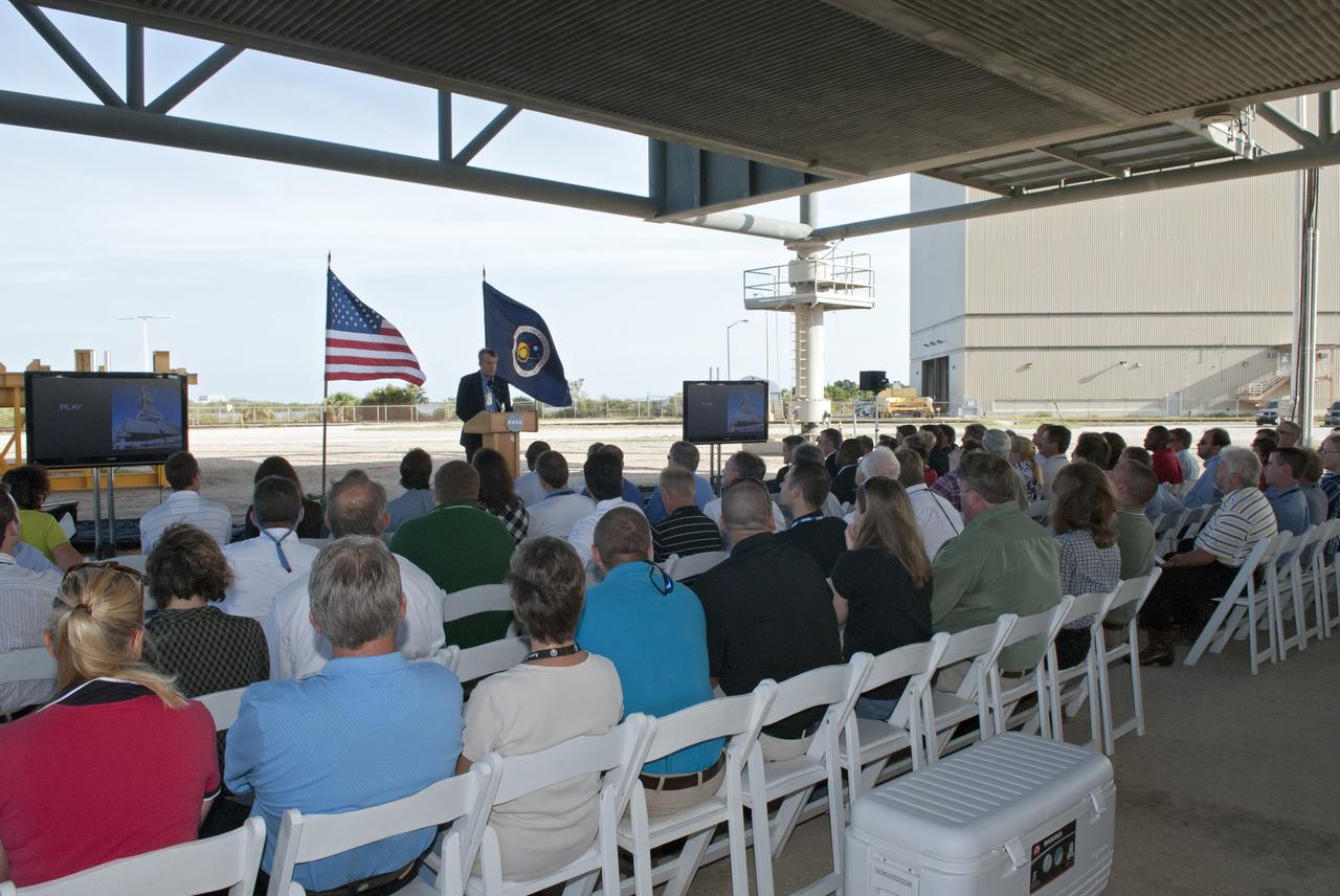CAPE CANAVERAL, Fla. -- At NASA's Kennedy Space Center in Florida, Constellation Senior Project Manager Larry Schultz talks to employees at a completion ceremony for NASA's new mobile launcher, or ML, support structure. The ceremony was held underneath the structure's launch mount opening. It took about two years to construct the launcher in the Mobile Launcher Park site, north of the Vehicle Assembly Building, or VAB. The 355-foot-tall structure will support NASA's future human spaceflight program. The base of the launcher is lighter than space shuttle mobile launcher platforms so the crawler-transporter can pick up the heavier load of the tower and a taller rocket. The next step will be to add ground support equipment, such as umbilicals and access arms, for future rocket launches. For information on NASA's future plans, visit www.nasa.gov. Photo credit: NASA/Jim Grossmann