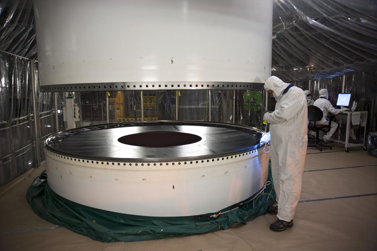 CAPE CANAVERAL, Fla. -- In the Vehicle Assembly Building at NASA's Kennedy Space Center in Florida, a technician double-checks the channel around the circumference of the left forward center solid rocket booster segment for dirt and debris before processing continues.        The booster along with its twin will be stacked on the mobile launcher platform along with an external fuel tank awaiting the arrival of space shuttle Endeavour for its flight to the International Space Station. As the final planned mission of the Space Shuttle Program, Endeavour and its crew will deliver the Alpha Magnetic Spectrometer, as well as critical spare components to the station on the STS-134 mission targeted for launch Feb. 26, 2011. For more information visit, http://www.nasa.gov/mission_pages/shuttle/shuttlemissions/sts134/index.html. Photo credit: NASA/Kim Shiflett