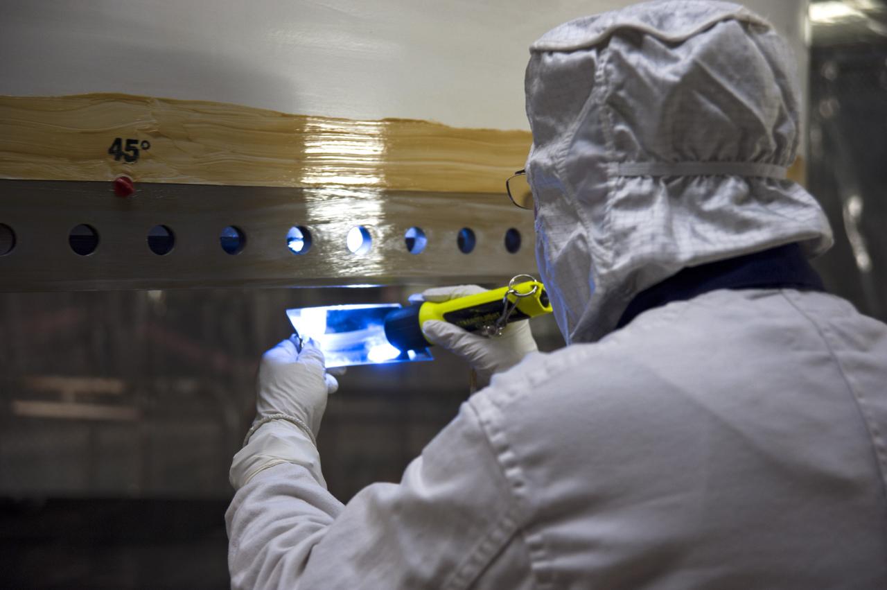 CAPE CANAVERAL, Fla. -- In the Vehicle Assembly Building at NASA's Kennedy Space Center in Florida,  an inspection is being performed on the bare metal parts of the "tang" end of the segment. The tang mates with the "clevis" and creates a field joint where each segment is put together. Grease has been coated on the bare steel to inhibit rust and corrosion.      The booster along with its twin will be stacked on the mobile launcher platform along with an external fuel tank awaiting the arrival of space shuttle Endeavour for its flight to the International Space Station. As the final planned mission of the Space Shuttle Program, Endeavour and its crew will deliver the Alpha Magnetic Spectrometer, as well as critical spare components to the station on the STS-134 mission targeted for launch Feb. 26, 2011. For more information visit, http://www.nasa.gov/mission_pages/shuttle/shuttlemissions/sts134/index.html. Photo credit: NASA/Kim Shiflett