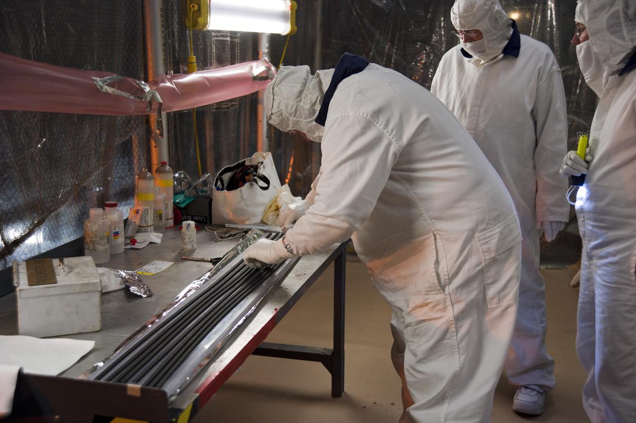 CAPE CANAVERAL, Fla. -- In the Vehicle Assembly Building at NASA's Kennedy Space Center in Florida, technicians select the rubber rings that will cushion and secure the left forward center solid rocket booster segments together.        The booster along with its twin will be stacked on the mobile launcher platform along with an external fuel tank awaiting the arrival of space shuttle Endeavour for its flight to the International Space Station. As the final planned mission of the Space Shuttle Program, Endeavour and its crew will deliver the Alpha Magnetic Spectrometer, as well as critical spare components to the station on the STS-134 mission targeted for launch Feb. 26, 2011. For more information visit, http://www.nasa.gov/mission_pages/shuttle/shuttlemissions/sts134/index.html. Photo credit: NASA/Kim Shiflett