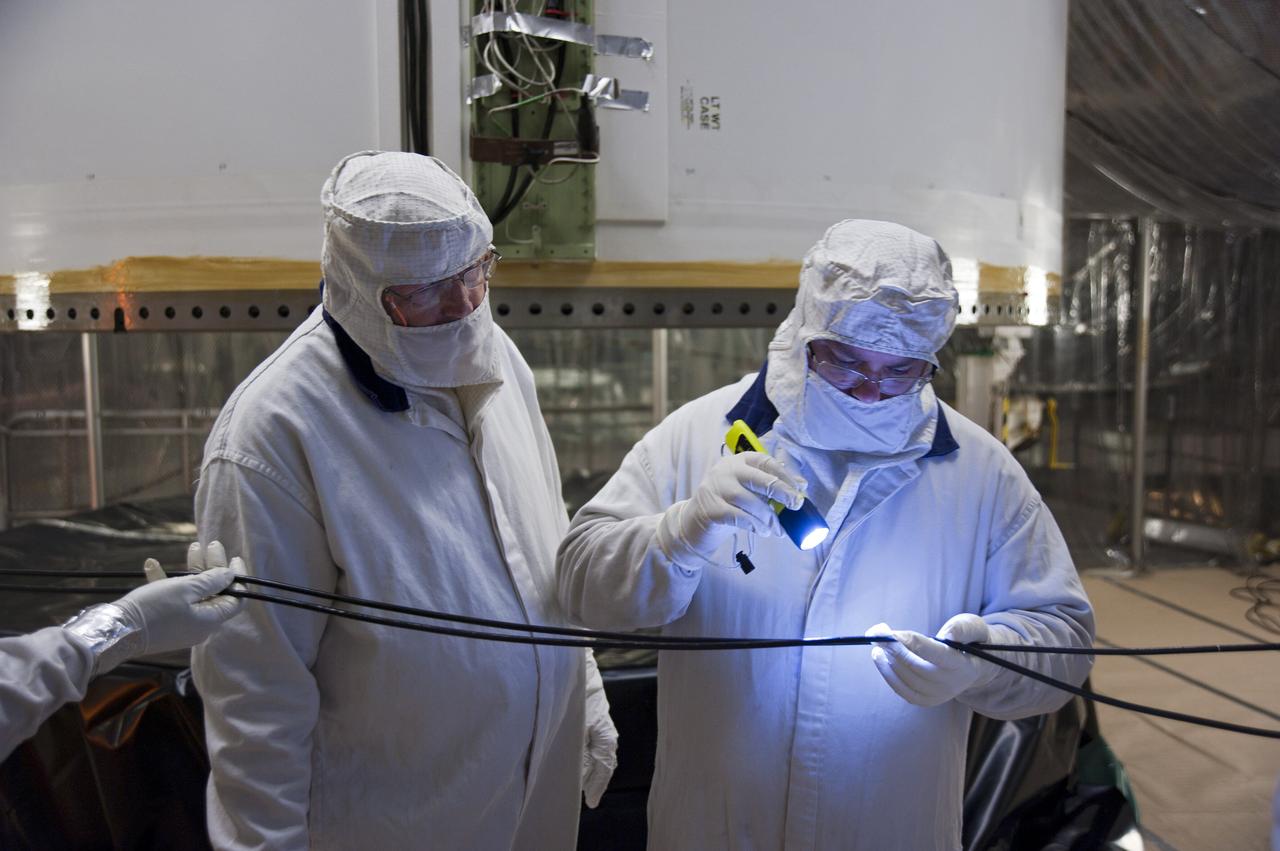CAPE CANAVERAL, Fla. -- In the Vehicle Assembly Building at NASA's Kennedy Space Center in Florida, a worker thoroughly inspects a rubber ring section with an ultraviolet light before installation on the left forward center solid rocket booster segment.        The booster along with its twin will be stacked on the mobile launcher platform along with an external fuel tank awaiting the arrival of space shuttle Endeavour for its flight to the International Space Station. As the final planned mission of the Space Shuttle Program, Endeavour and its crew will deliver the Alpha Magnetic Spectrometer, as well as critical spare components to the station on the STS-134 mission targeted for launch Feb. 26, 2011. For more information visit, http://www.nasa.gov/mission_pages/shuttle/shuttlemissions/sts134/index.html. Photo credit: NASA/Kim Shiflett